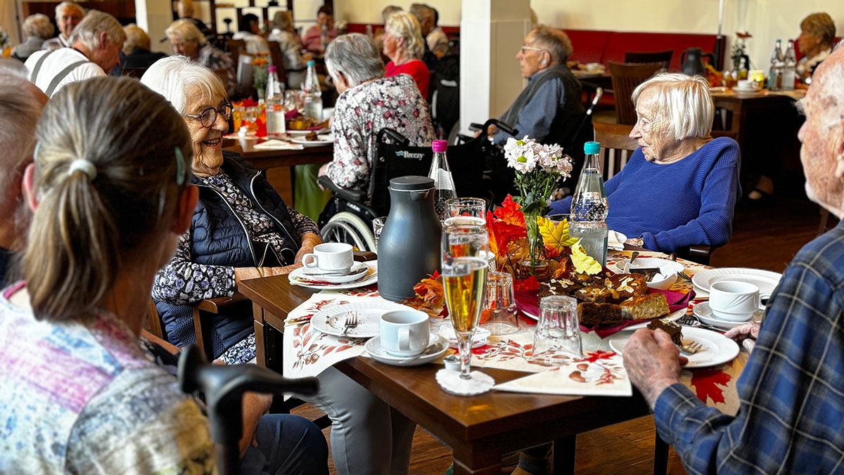 Senior citizens from the Bölschestraße Senior Living Center are sitting at decorated tables